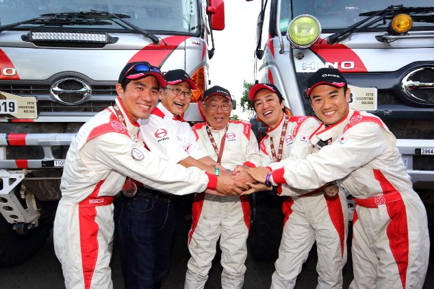 The Hino team and Masakazu Ichikawa celebrate.